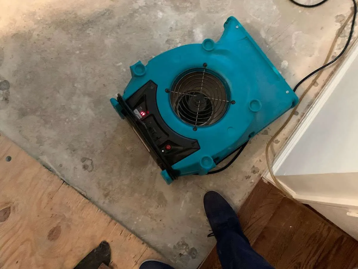 Air mover drying subfloor during Commercial Water Damage Restoration in Marinette